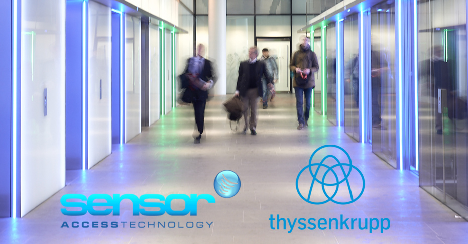 Image of men walking down a corridor adjacent to lifts, with the Sensor and Thyssen logos seen at the bottom of the image